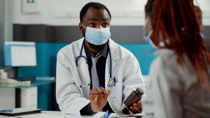 Maternity specialist and pregnant woman with face mask at checkup visit Maternity specialist and pregnant woman with face mask at checkup visit